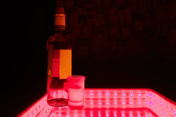 Studio shot of bottle with glass of vodka - 写真・画像