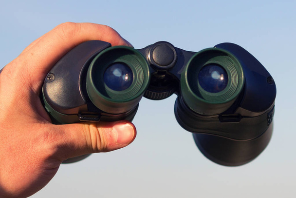 binocular in mans hands - Fotó, kép