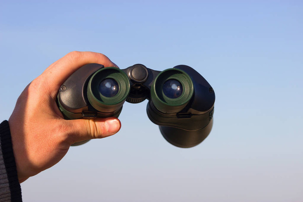 binocular in mans hands - Fotó, kép
