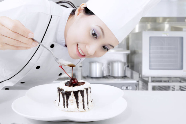 Female chef preparing sweet cake - Fotó, kép