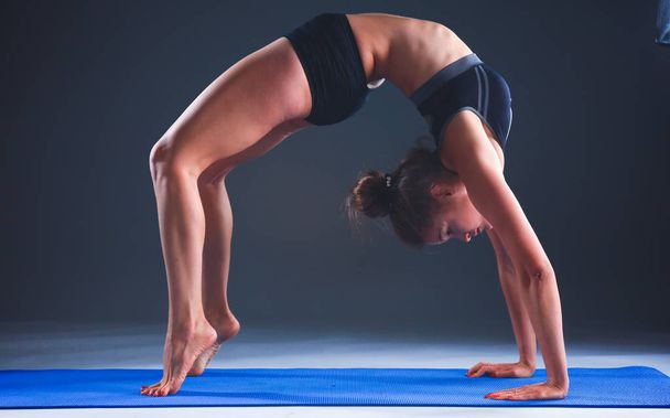 Portrait of sport girl doing yoga stretching exercise - Foto, imagen