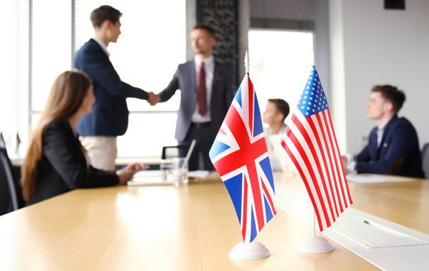 European Union and American leaders shaking hands on a deal agreement. - Φωτογραφία, εικόνα