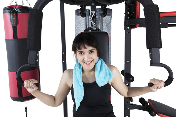 Young girl exercising on weights machine - Photo, Image