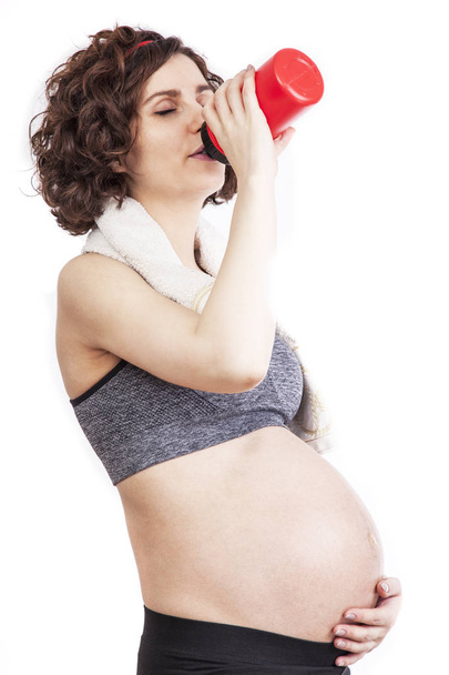 Young pregnant woman practicing fitness. - Photo, Image
