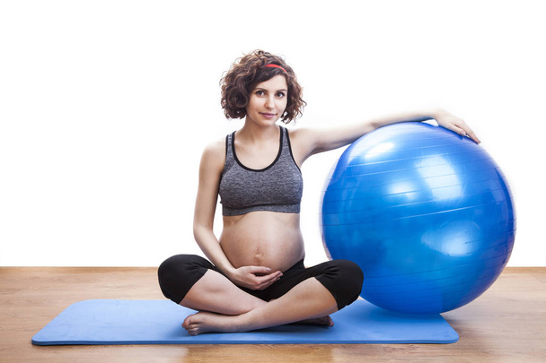 Young pregnant woman exercises with the ball - Photo, Image