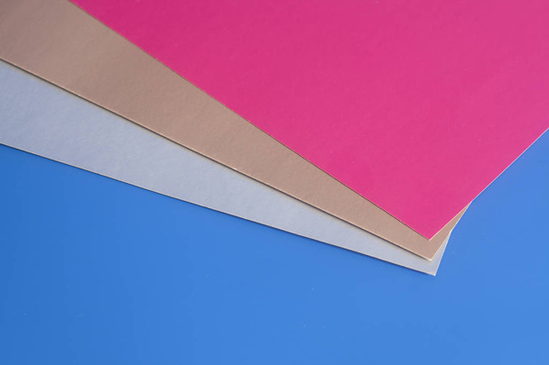 Colourful paper sheets on blue background - Photo, Image