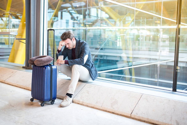 Man unhappy and frustrated at the airport his flight is cancelle - 写真・画像