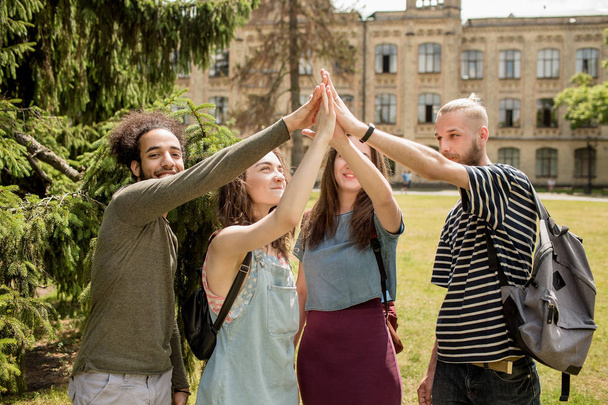Students at campus rising hands. - Fotografie, Obrázek