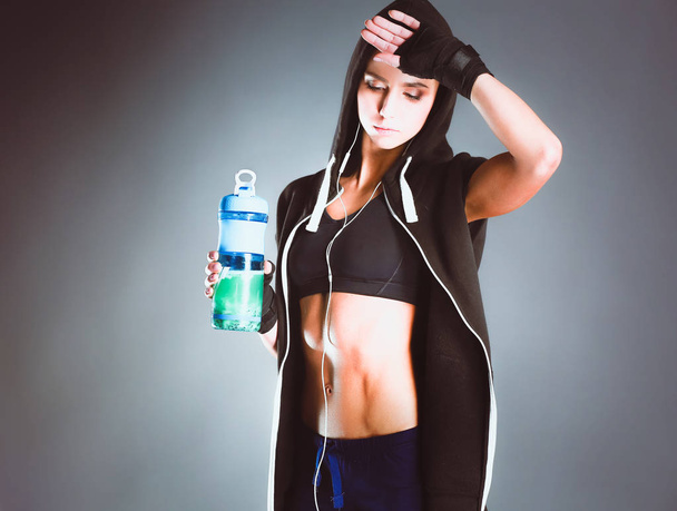 Girl with bottle in hands after sport. - Fotó, kép
