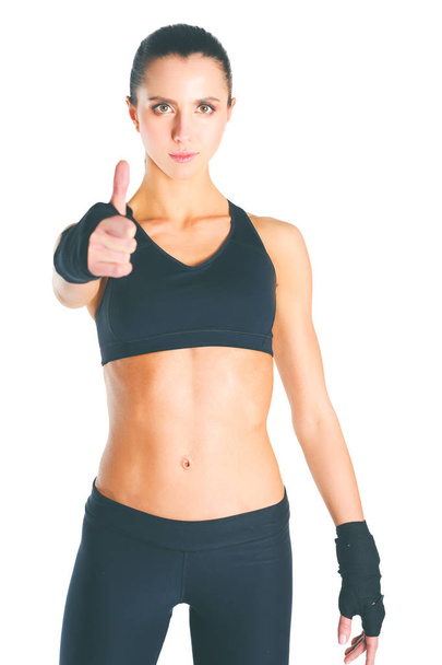 Portrait of a happy fitness woman showing ok sign. - 写真・画像