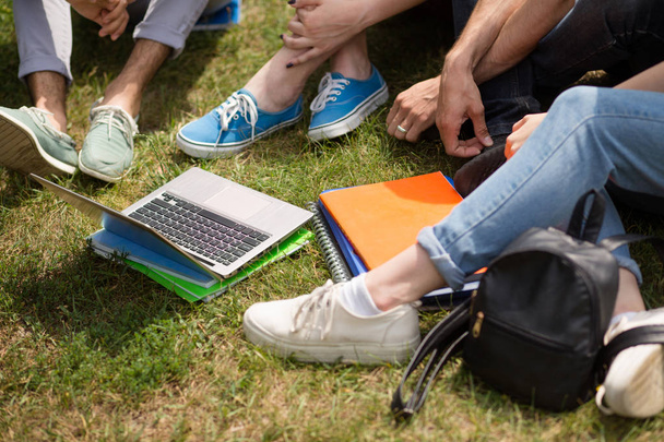 Close up view of students legs on the grass. - Valokuva, kuva