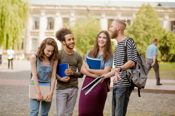 College friends standing, laughing in campus. - Fotoğraf, Görsel