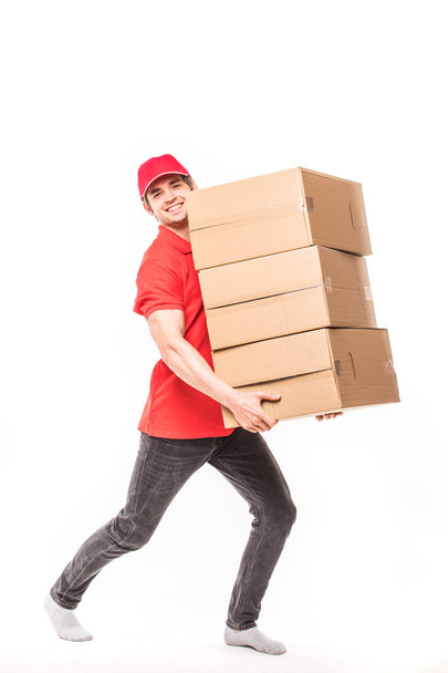 Delivery Man carries hard boxes on white - Photo, Image