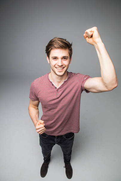 Muscle man hands up show muscle posing in studio isolated over a grey background - Foto, immagini