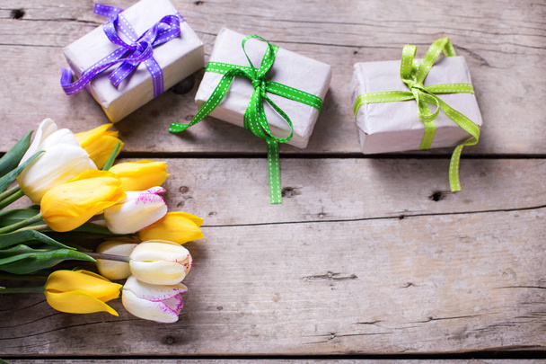 Yellow  spring tulips and box with presents  - Valokuva, kuva