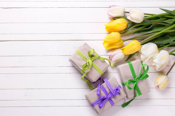 Bright yellow  spring tulips and box with presents  - Zdjęcie, obraz