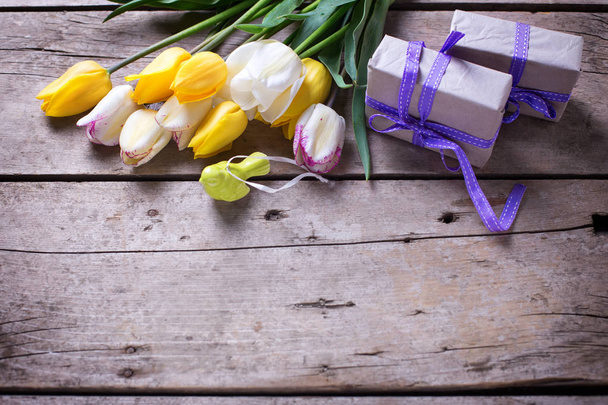 Border from  spring tulips and wrapped  presents   - 写真・画像