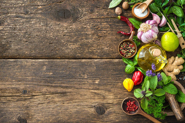 Fresh herbs and spices on wooden table - 写真・画像