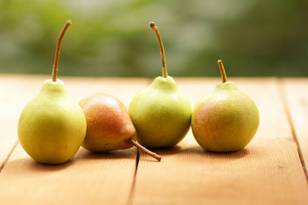 Pears on the background of a green bokeh - Foto, imagen