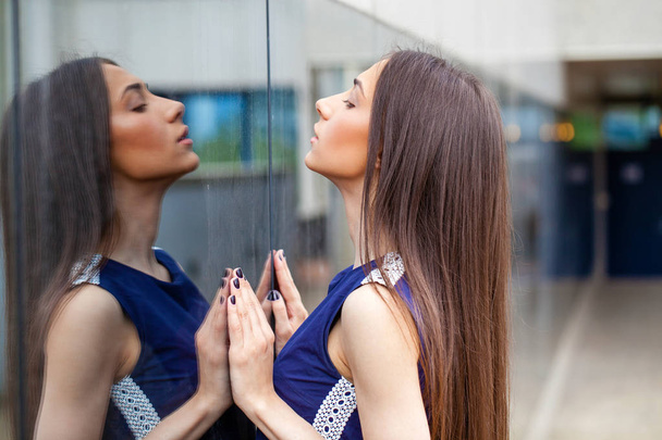 Stylish lady in blue dress posing near mirrored wall - Foto, Imagen