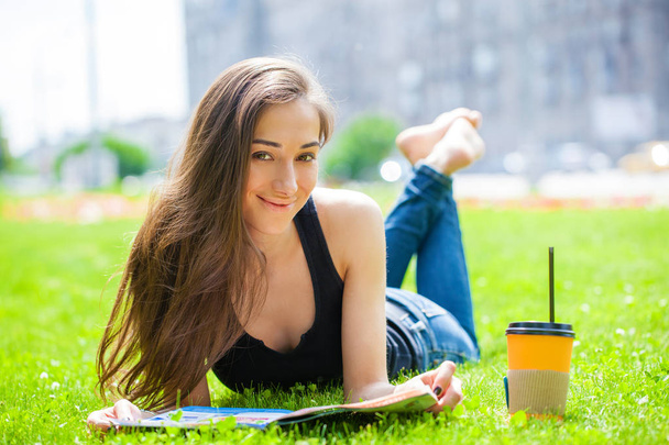 Young beautiful brown haired woman in blue jeans  - Photo, image