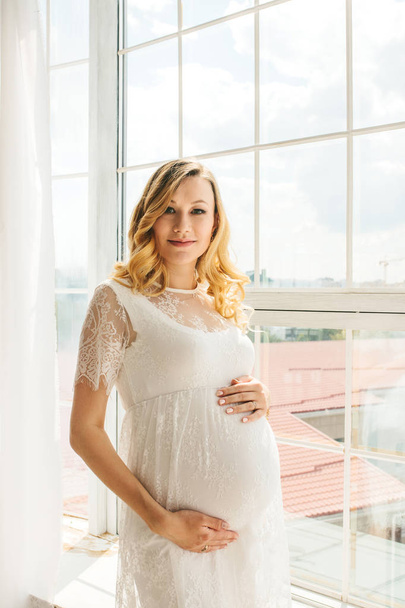 Beautiful adult pregnant woman. Waiting for the baby. Pregnancy. Care, tenderness, motherhood, childbirth. - Fotografie, Obrázek