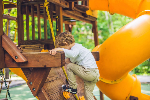 boy is playing on  wooden playground - Zdjęcie, obraz