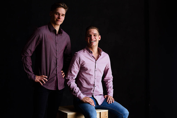 Lifestyle portrait of two handsome boys tween brothers in loft studio - Fotó, kép