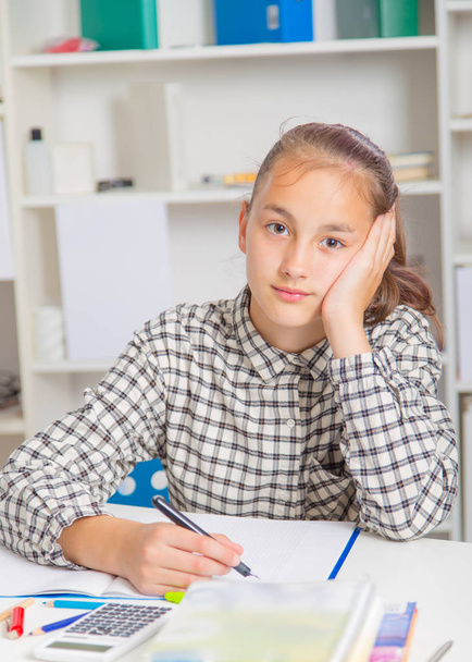 Teenage girl preparing for exams. Teenage girl doing homework for school. - Zdjęcie, obraz