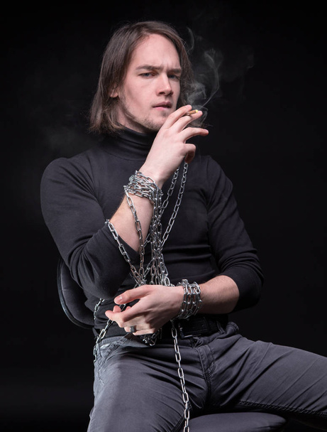 Smoking young man and chain - Photo, Image