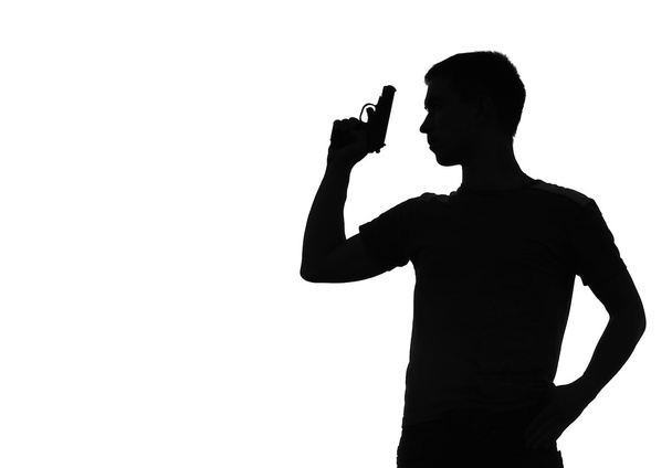 Silhouette of the man with a pistol - Photo, Image