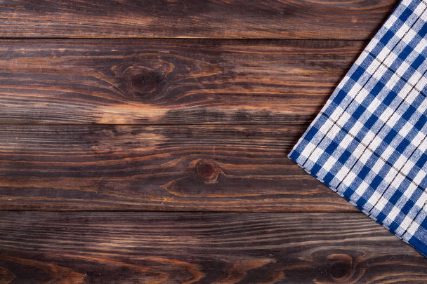 blue checkered tablecloth on the black wooden table with copy sp - Foto, Imagem