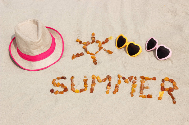Shape of sun with word summer and accessories for vacation on sand at beach - Foto, afbeelding