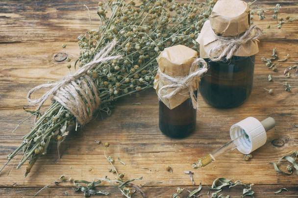 bunch of herb wormwood, jars of oil, - Photo, image