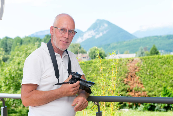  mature man with dslr camera, outdoors - Photo, Image