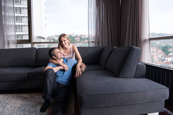 young handsome couple hugging on the sofa - Foto, Imagen