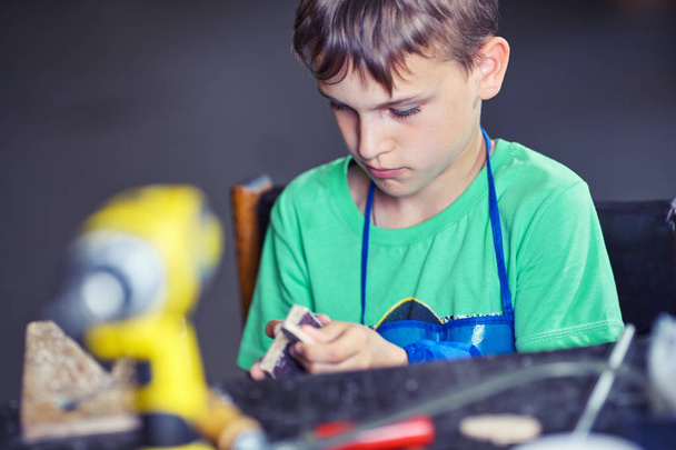Child in the workshop working tool - Foto, Imagen