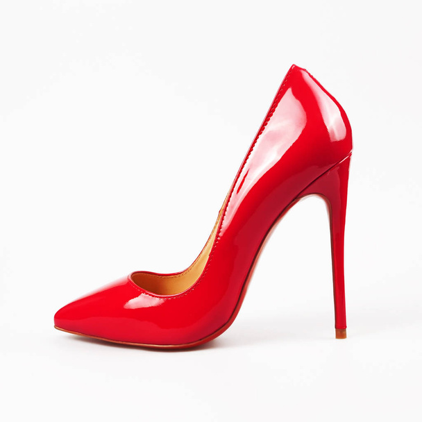 female red high-heeled shoes over white  - Foto, Imagem