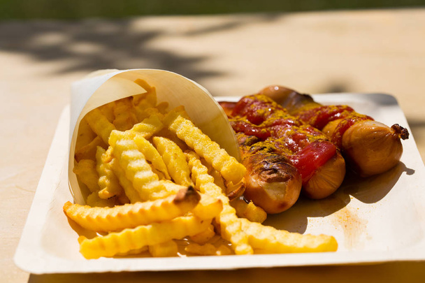 Currywurst and pommes on recyclable dishes - Photo, Image