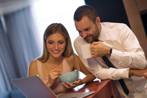 A young couple is preparing for a job and using a laptop - Photo, image