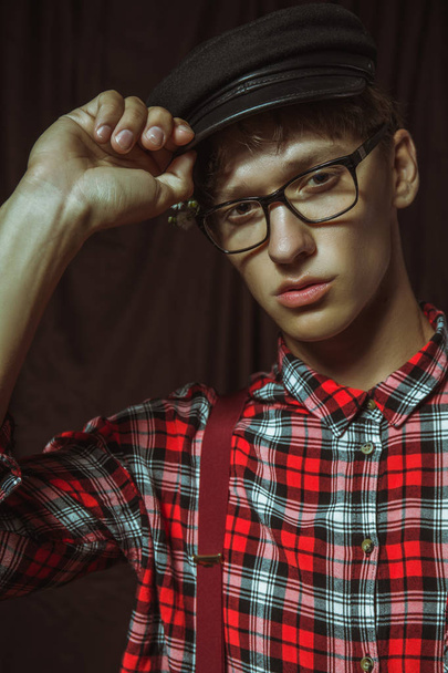 Attractive guy in glasses corrects his cap - Photo, Image