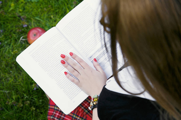 Girl reading book / student reading a book/ in park /Beautiful student studying - Photo, Image