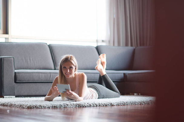 young woman using tablet computer on the floor - Photo, image