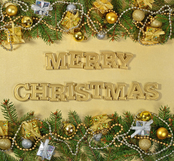 Feliz Natal texto dourado e ramo de abeto e deco de Natal
 - Foto, Imagem