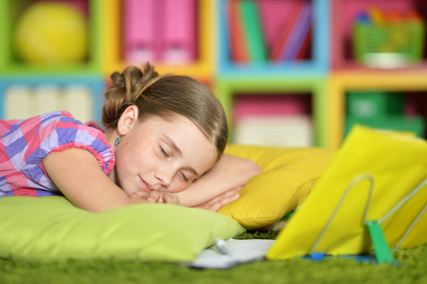 Schoolgirl sleeping on exercise book - Foto, Imagen