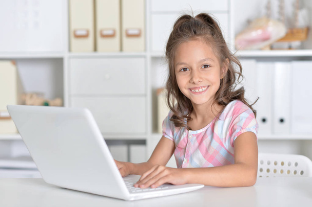Little girl using laptop - Фото, изображение