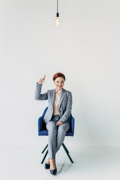 businesswoman pointing at light bulb - Photo, Image
