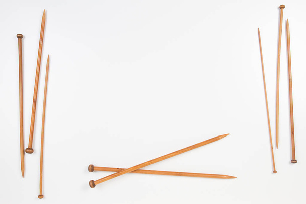 Wooden knitting needles frame with copy space for text on white background - Фото, зображення