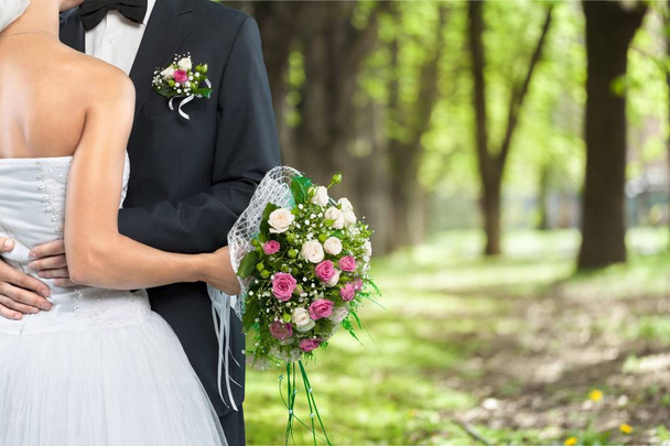 bride and groom holding stylish bouquet - Zdjęcie, obraz