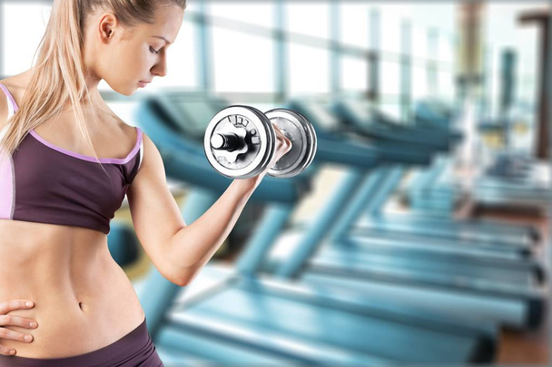 woman with dumbbell in gym - Foto, Bild